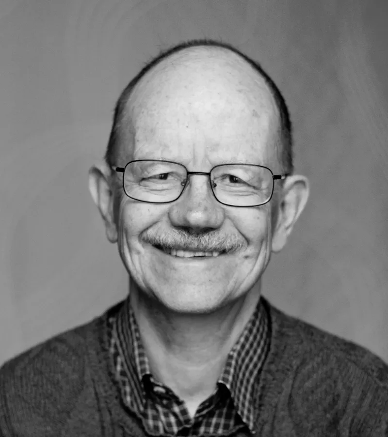 Nils Petter Gleditsch, smiling, in glasses, a checked shirt and a sweater